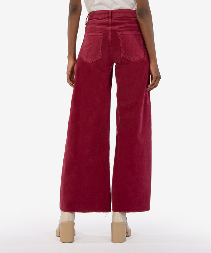 Back view of model wearing pants. Shows the back pockets. Also shows the wide leg, corduroy texture and the beautiful color ruby. 