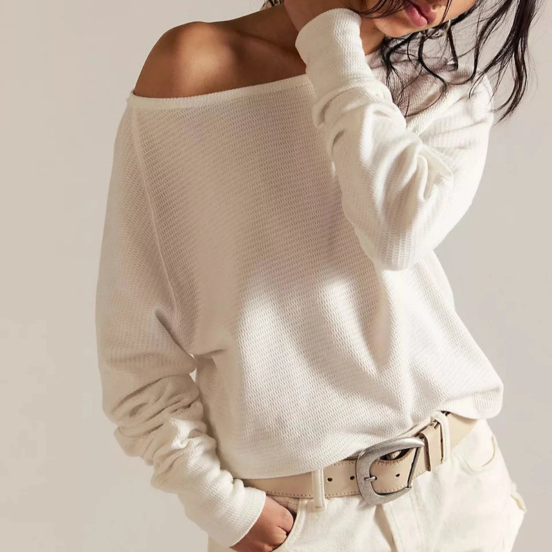 front view of the model wearing the jess long sleeve. shows the off the shoulder boat neckline. also shows the dolman sleeves, the thermal texture and the ivory color. 