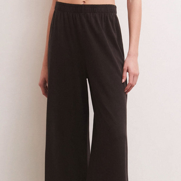 front view of the model wearing the scout cotton jersey pant. shows the elastic waist. also shows the relaxed and somewhat of the wide leg. 