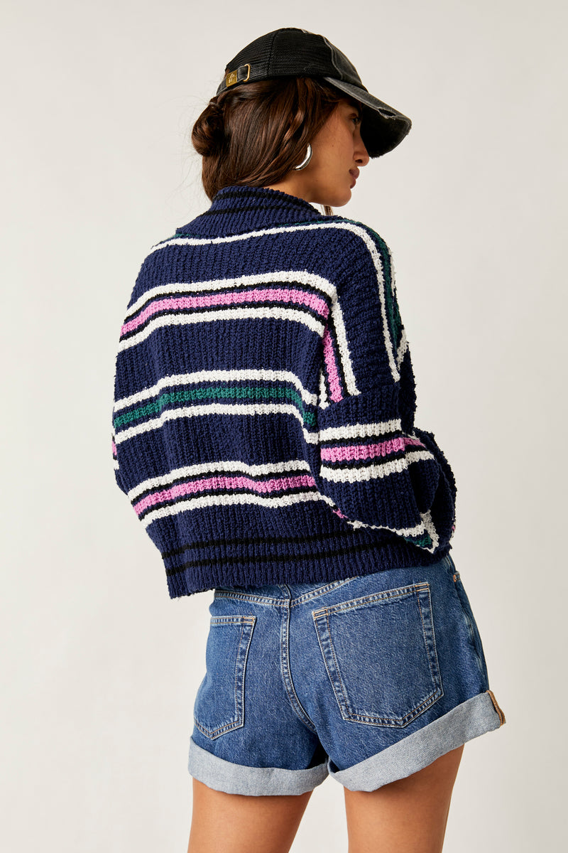 back view of model wearing the Kennedy pullover. shows the collared neck. also shows drop shoulders, the stripe detailing and the boxy fit.