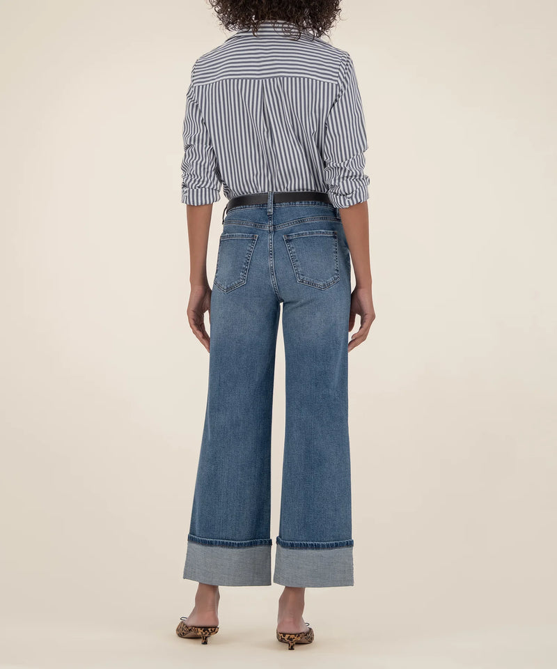 back view of the model wearing the meg high rise wide leg jean. shows the back pockets. also shows the cuffed hem, the belt loops and the wide legs. 