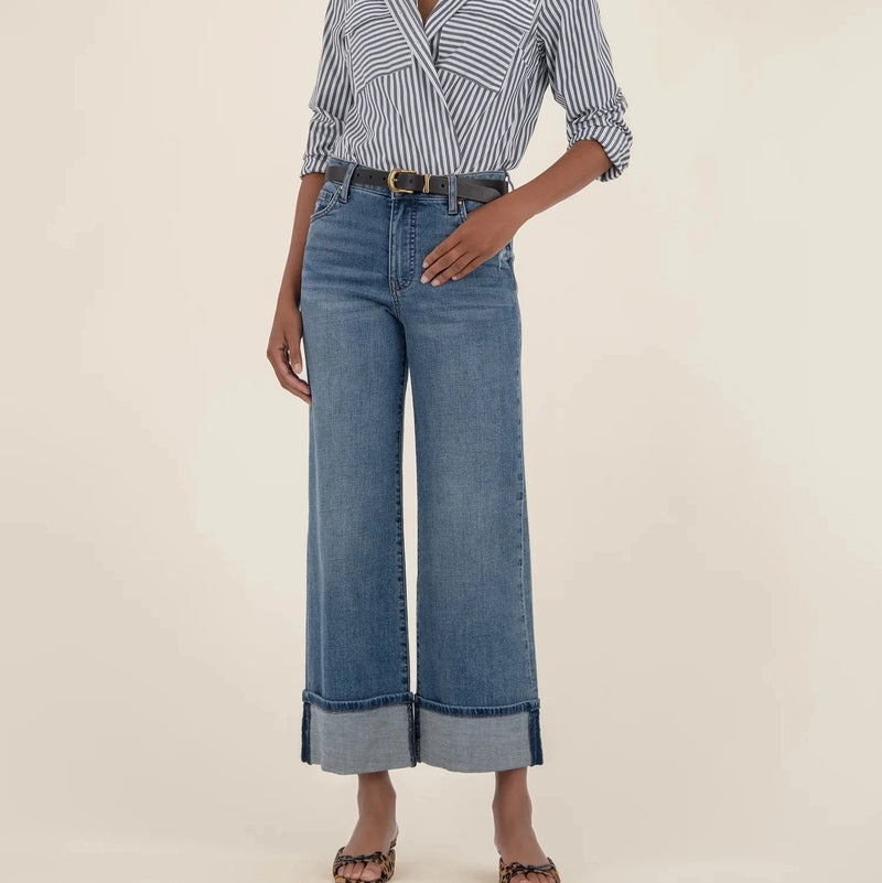 front view of the model wearing the meg high rise wide leg jean. shows the cuffed hem. also shows the high rise, the front pockets, the button/ zipper closure and the wide leg. 