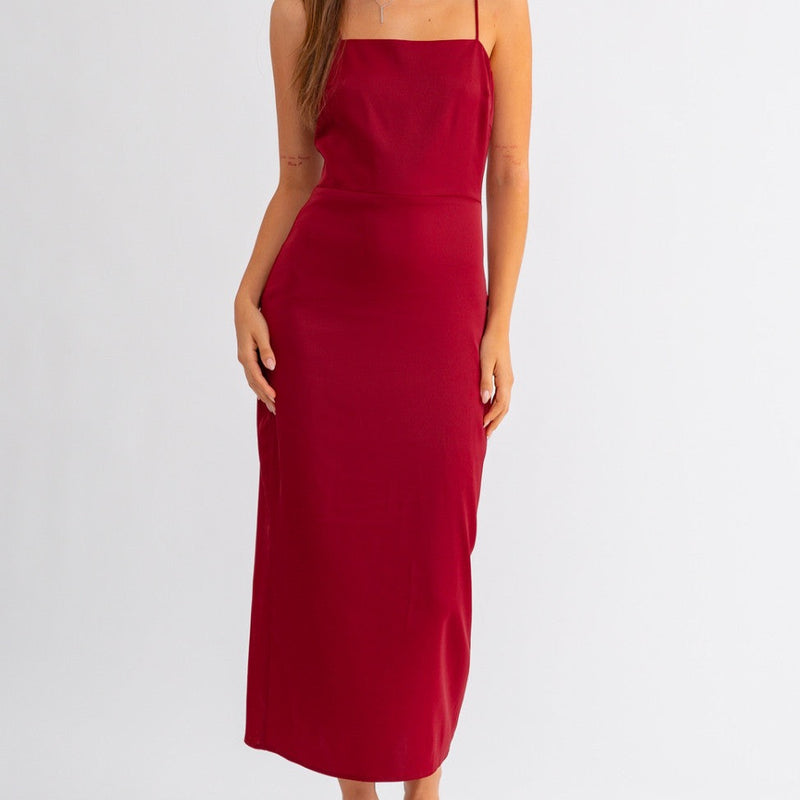Front view of model wearing dress. Shows the square neckline. Also shows the spaghetti straps, the seam detail throughout the waist and the beautiful maroon color. 