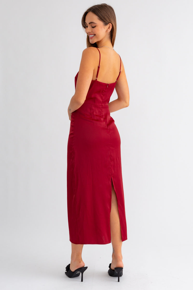 Back view of the model wearing dress. Shows the adjustable straps. Also shows the back zipper closure, the back slit and the beautiful maroon color. 