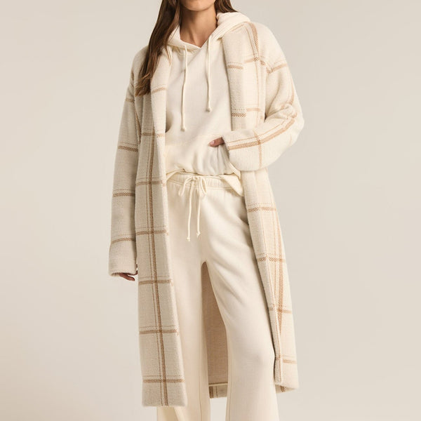 front view of the model wearing the mason windowpane coat. shows the collar. also shows the long length, the windowpane design. 