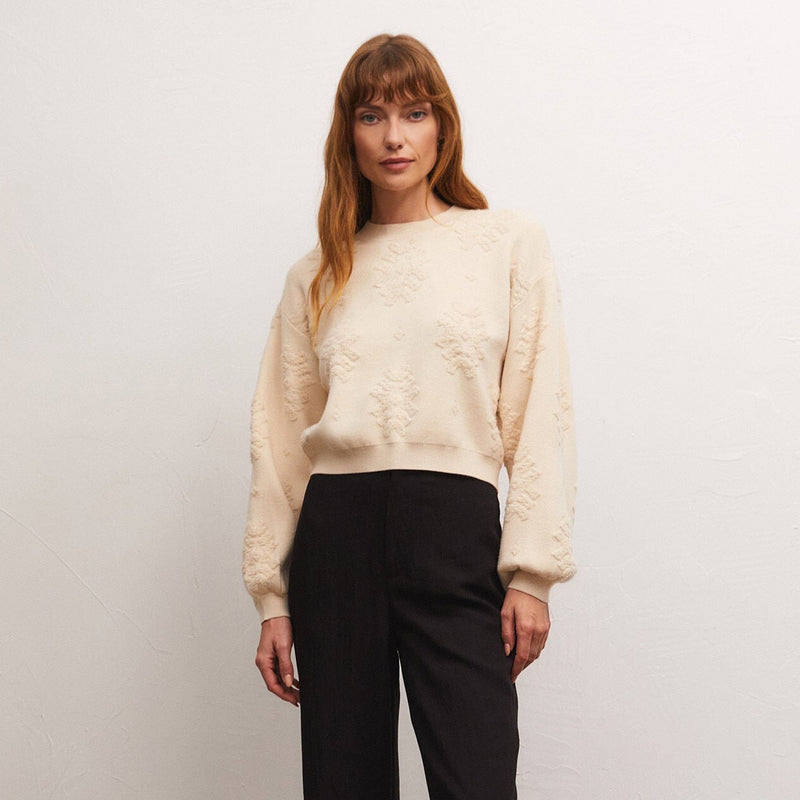 front view of the Malin sweater top in dove. shows the crew neckline. also shows the textured detail throughout, the blouson sleeves and the length hits at the waist. 