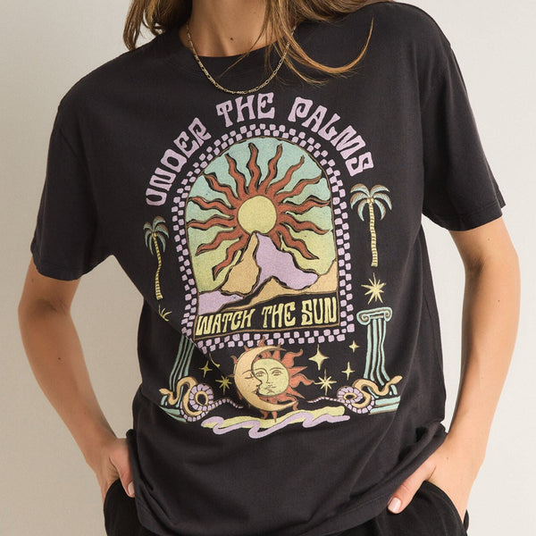 front view of the model wearing the under the palms tee. shows the crew neckline. also shows the screenprint, the oversized fit and the short sleeves. 
