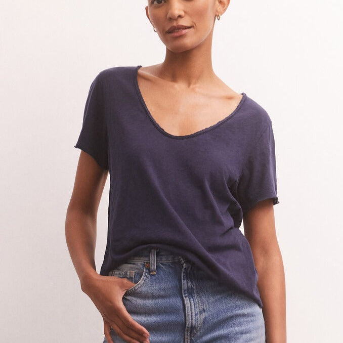 shows front view of model in inca tee. shows the wide scoop neckline and looser fit.