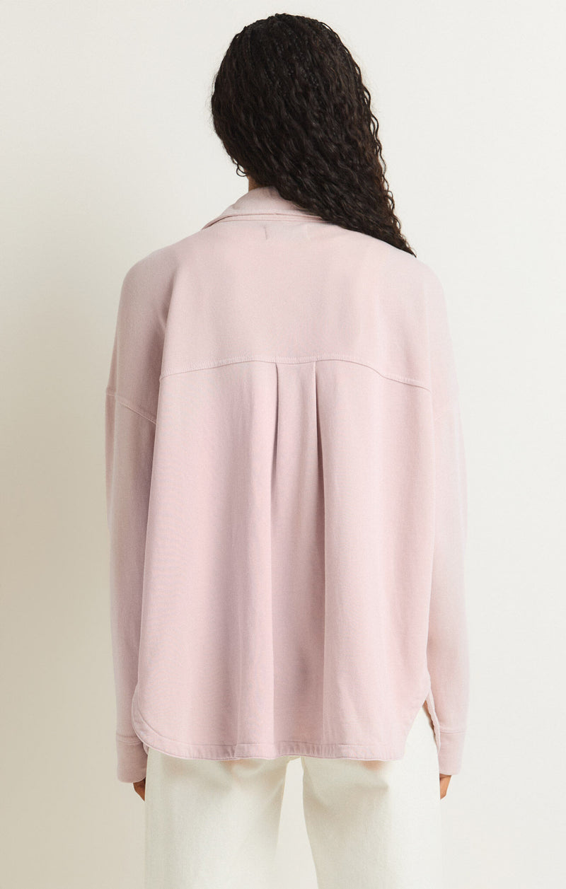 back view of the model wearing the all day knit jacket. shows the drop shoulders. also shows the scalloped hem and the collar. 