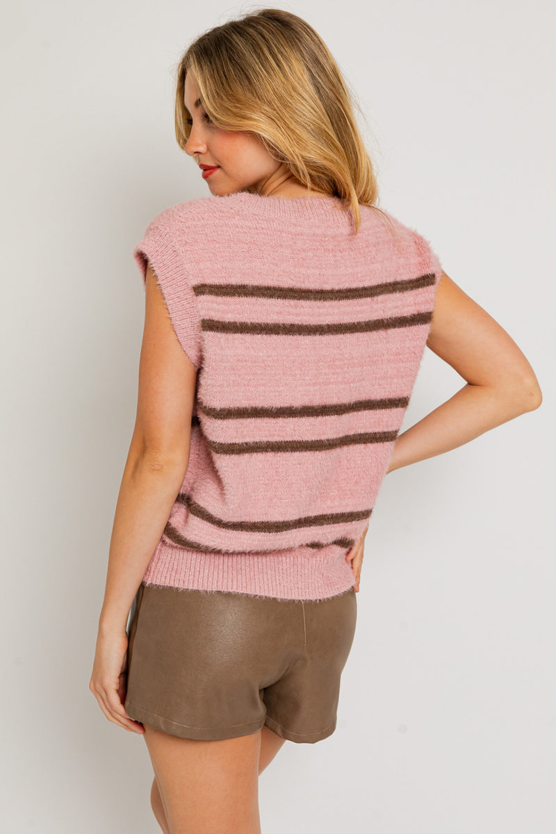 back view of the susie sweater vest in pink/brown. shows the cap sleeves. also shows the brown stripe detail, the oversized fit and the ribbed hem and sleeve cuffs.