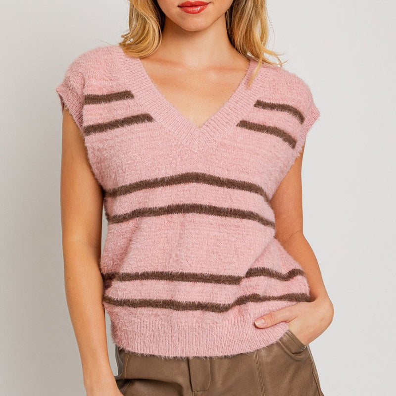 front view of the susie v neck sweater vest. shows the v neckline. also shows the pink background with the brown stripe detail, also shows the cap sleeves and the fuzziness of the vest. 