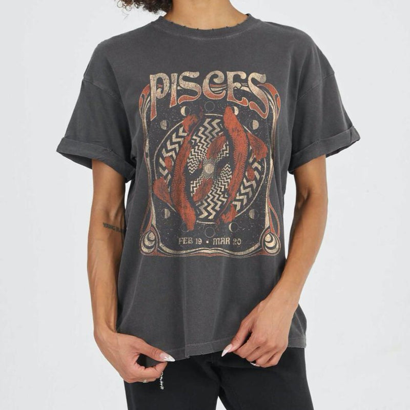 Front view of model wearing tee. Shows the crew neckline. Also shows the cuff sleeves, distressing on neckline and the pisces zodiac graphic. 