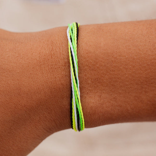 Model wearing bracelet. Shows the different colors of neon yellow, lime green, white & black. 