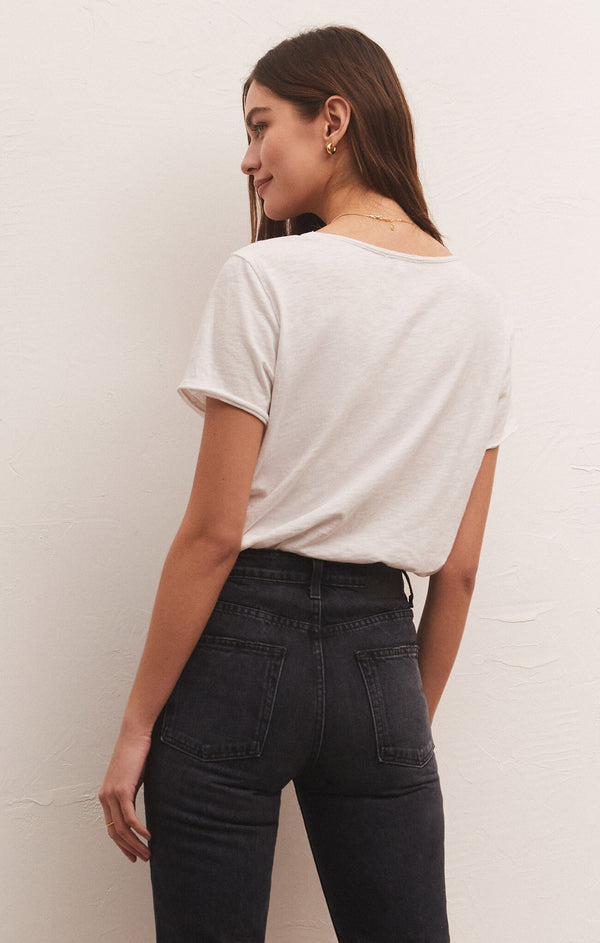 shows back view of model in white tee. shows short sleeves and looser fit.