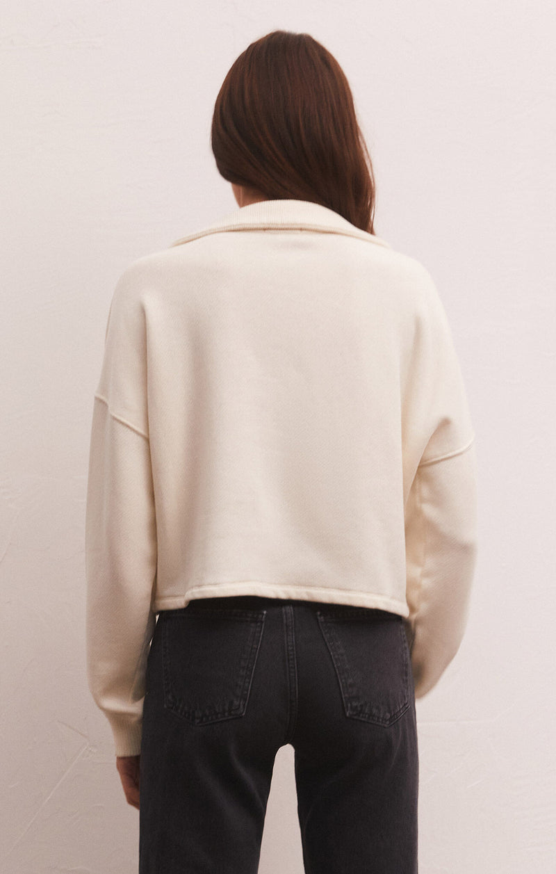 back view of model in sweatshirt. shows the collar, dropped shoulders and relaxed fit.