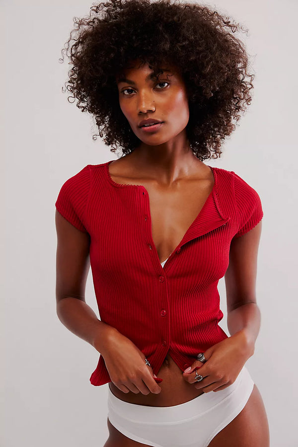 front view of the model wearing most wanted cardi in the red color, the picot trim, and the ribbed detailing.