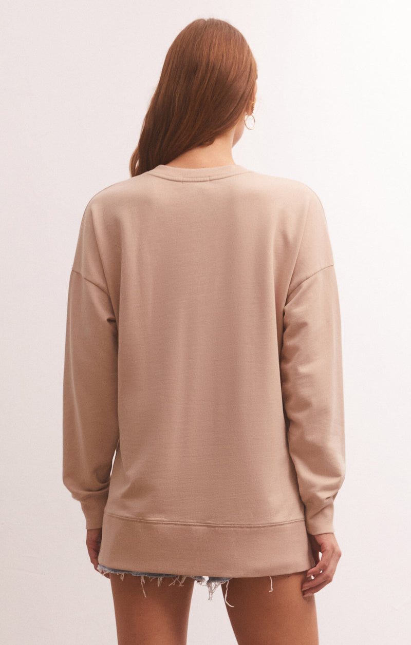 back view of model in shirt. shows dropped shoulders and oversized fit.