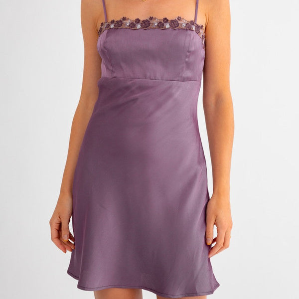 Front view of model wearing dress. Shows the spaghetti straps. Also shows the lave trim on the top and the beautiful purple color. 