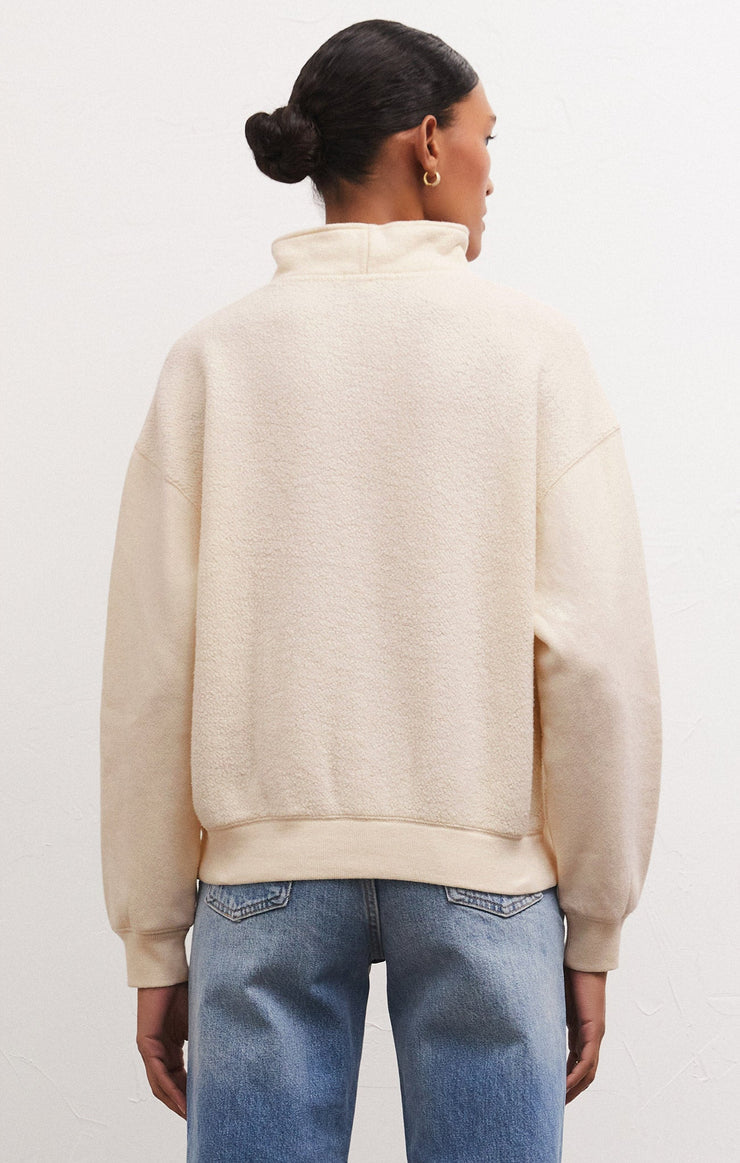 Back view of model wearing sweatshirt. Shows the relaxed fit. also shows the reverse fleece the drop shoulders and the sandstone color. 