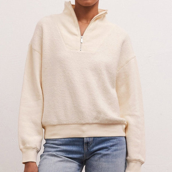 Front view of model wearing sweatshirt. Shows the half zip detail. Also shows the mock neck, drop shoulders and this beautiful sandstone color. 