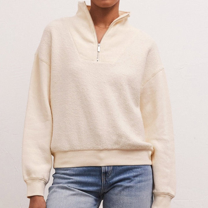 Front view of model wearing sweatshirt. Shows the half zip detail. Also shows the mock neck, drop shoulders and this beautiful sandstone color. 