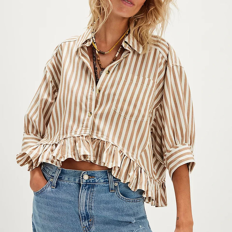 Front view of the model wearing the bailey striped shirt. shows the ruffle hem. also shows the collared neckline, the front patch pockets, the tan and white stripes. and the 3/4 sleeves. 