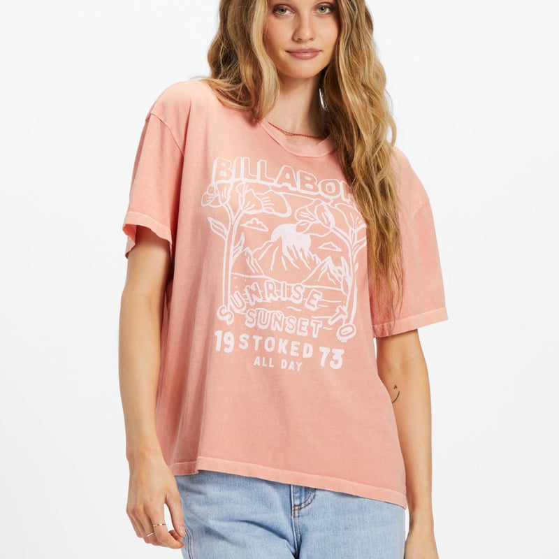 Front view of model wearing t shirt. Shows the crew neck. Also shows the short sleeve, the fun graphic and the beautiful peach color.