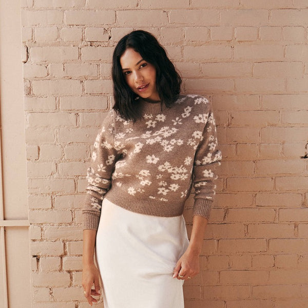 Front view of model wearing sweater. Shows the mock neck. Also shows the abstract flower print, the fitted bottom band and the beautiful campfire color with cream flowers.