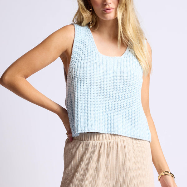 front view of the model wearing the sundays tank. shows the scoop neckline. also shows he knit material, the drooped armholes and the loose fit. 