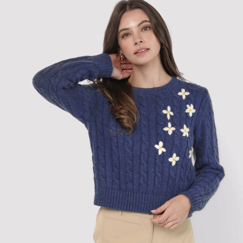 front view of the model wearing the lulu embroidered daisy sweater. shows the crew neckline. also shows the embroidered daisies, the waist length and the navy color. 