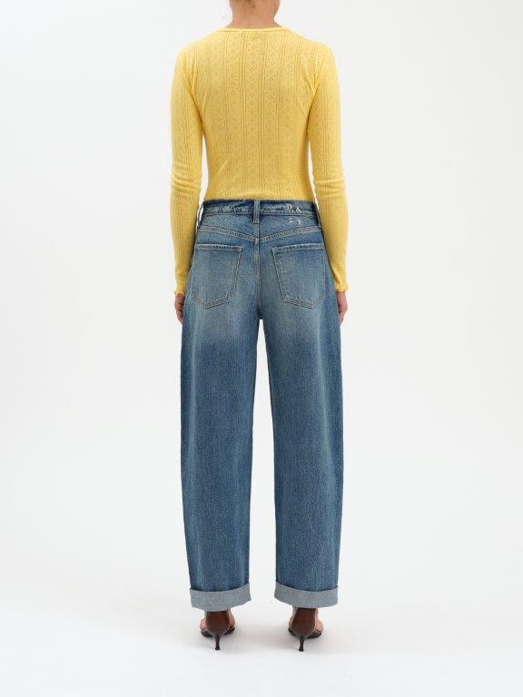 Person wearing a yellow sweater and blue jeans on a white background