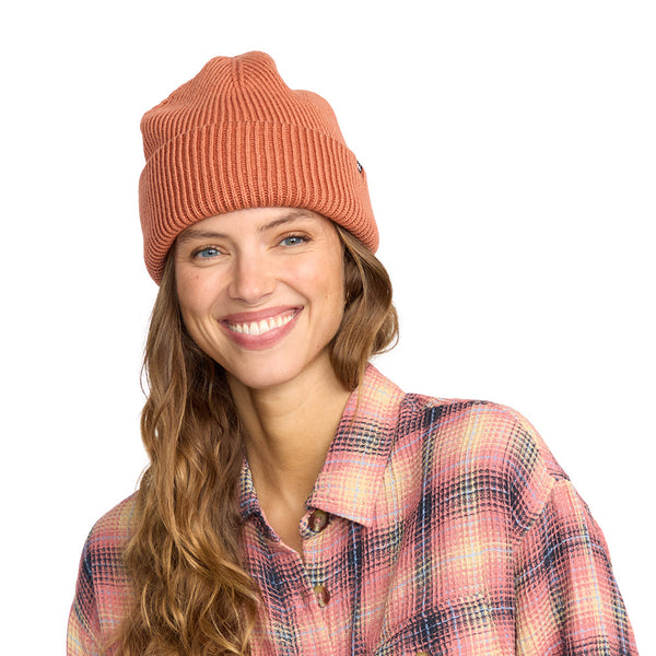 shows model wearing the wave check beanie. shows the ribbed detailing, the chunky style and the reddish/orangish color.