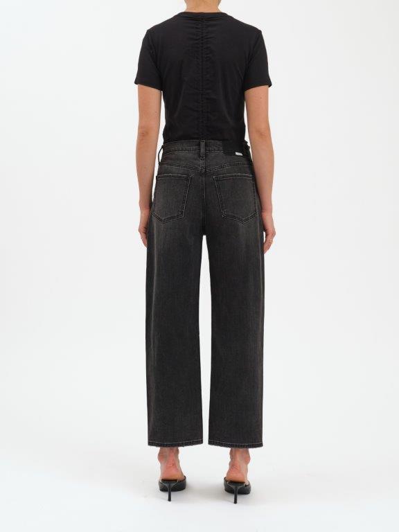 Person wearing black jeans and a black top on a white background