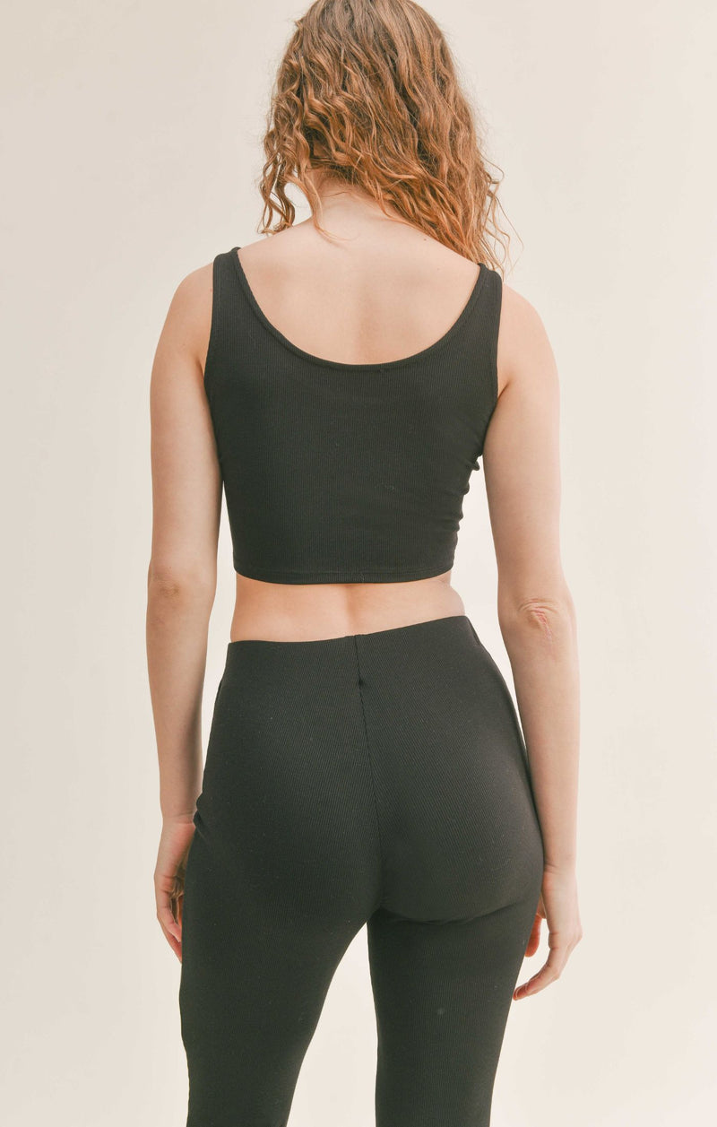 Back view of model wearing the tank. Shows the back scoop. Also shows the super cropped fit. 