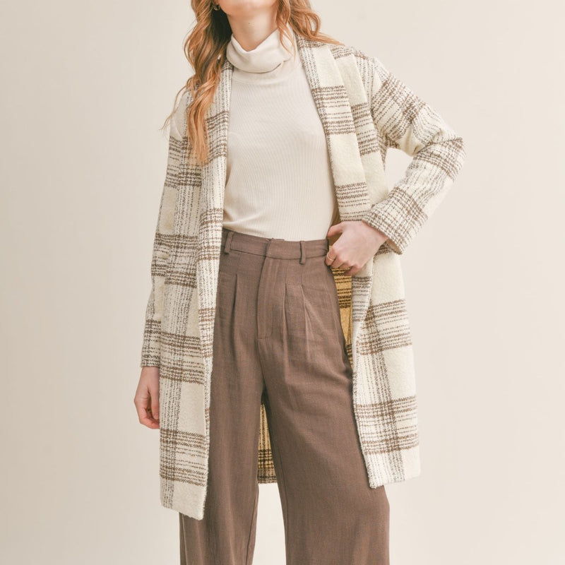 Front view of model wearing jacket. Shows the knee length of the jacket. Also shows the collar.
