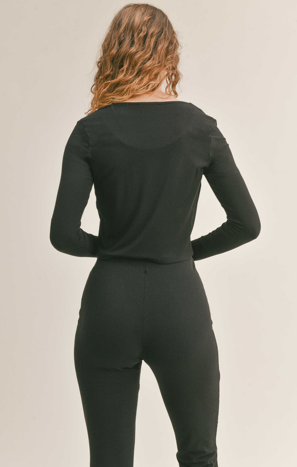 Back view of model wearing the cardigan. Shows the cropped fir. Also shows the long sleeves. 