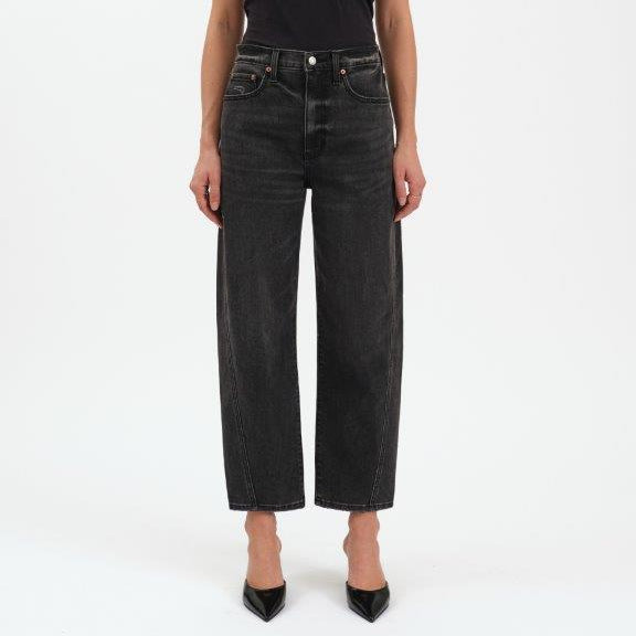 Person wearing black jeans and a black t-shirt on a white background