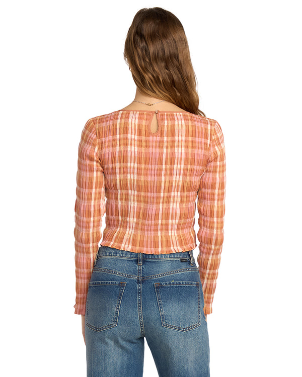 Person wearing a plaid shirt and jeans on a white background