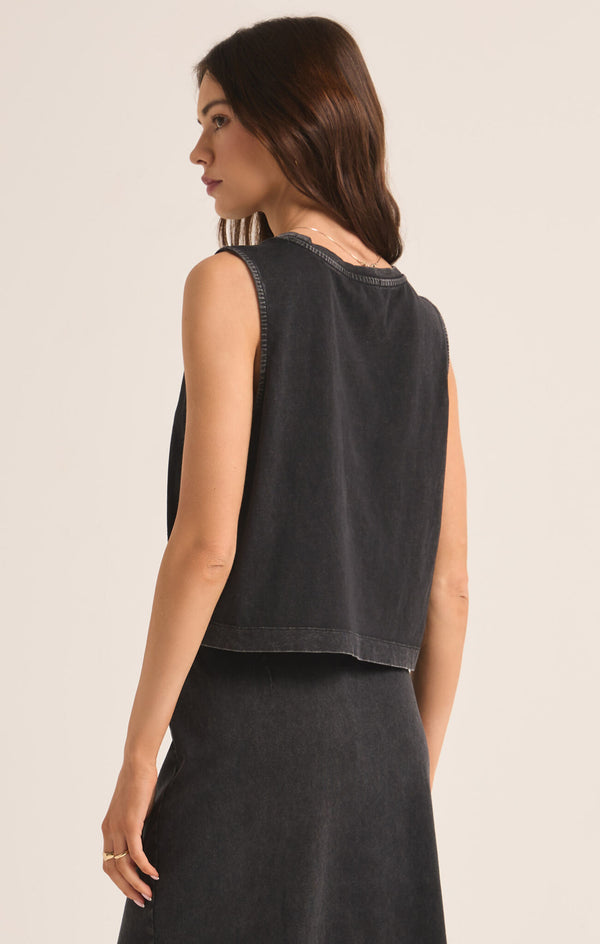 back view of the model wearing the sloane jersey muscle tank. shows the relaxed body. also shows the flowy fit, and the waist length. 
