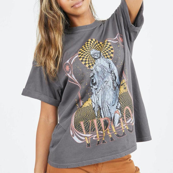 Front view of model wearing tee. Shows the crew neckline. Also shows the cuff sleeves, distressing on neckline and the virgo zodiac graphic. 