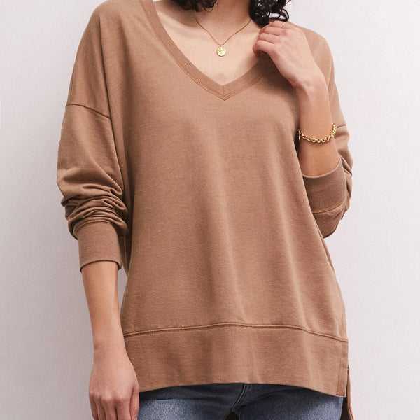 Front view of model wearing weekender. Shows the V-neckline. Also shows the oversized fit, side slits, hi lo hem, and this beautiful color mink. 