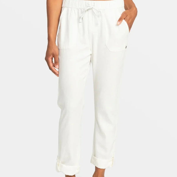 front view of the model wearing the on the shore cargo pants in white. shows the drawcord closure. also shows the synched waist, the front pockets and the roll able cuff at the bottom. 