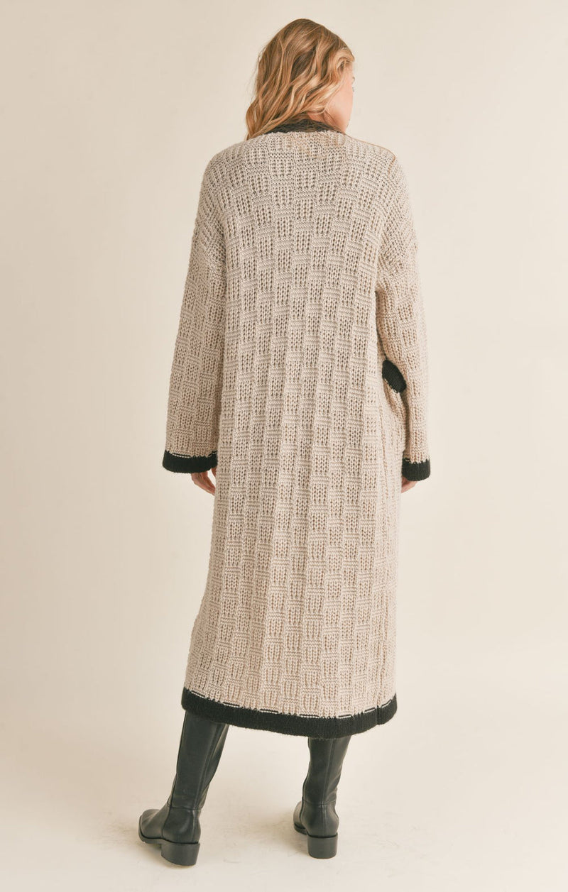 back view of the Zenni cardigan in taupe. shows the drop shoulders. also shows the oversized sleeves, the back trimming detail and the longer length. 