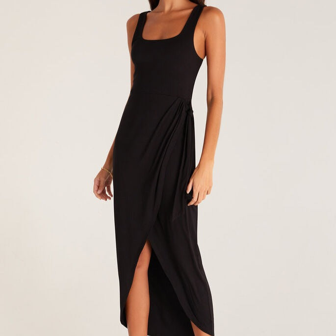 shows front view of midi dress featuring a square neckline, thick straps, draping skirt, and a tie detail on the side.