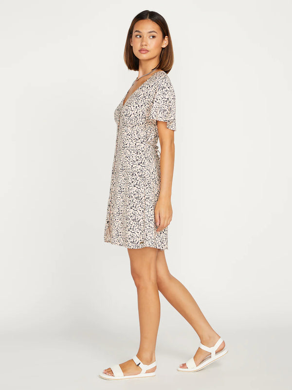 side view of model in dress. shows the flutter sleeves, hits model about mid thigh.