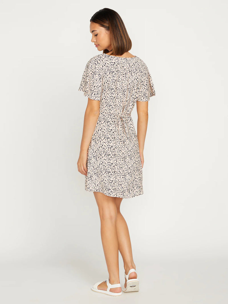 back view of model in dress. shows off the flutter sleeves and the the tie back detail to make it more fitted.
