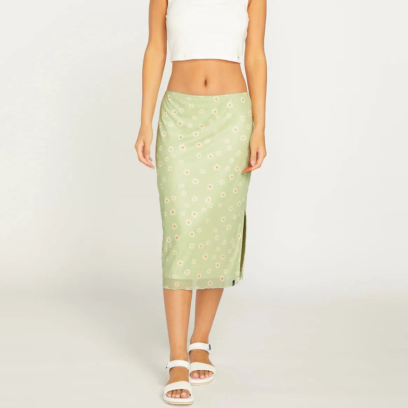 front view model wearing the green skirt. shows the low waist, mesh overlay and the side slit.