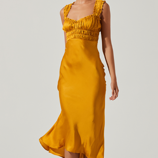 front view of model in mustard dress. shows the sweetheart neckline and smocked bust and straps