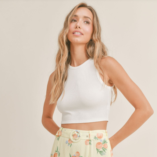 shows front view of the fitted tank. shows high neckline and ribbed fabrication. hits model above the belly button.