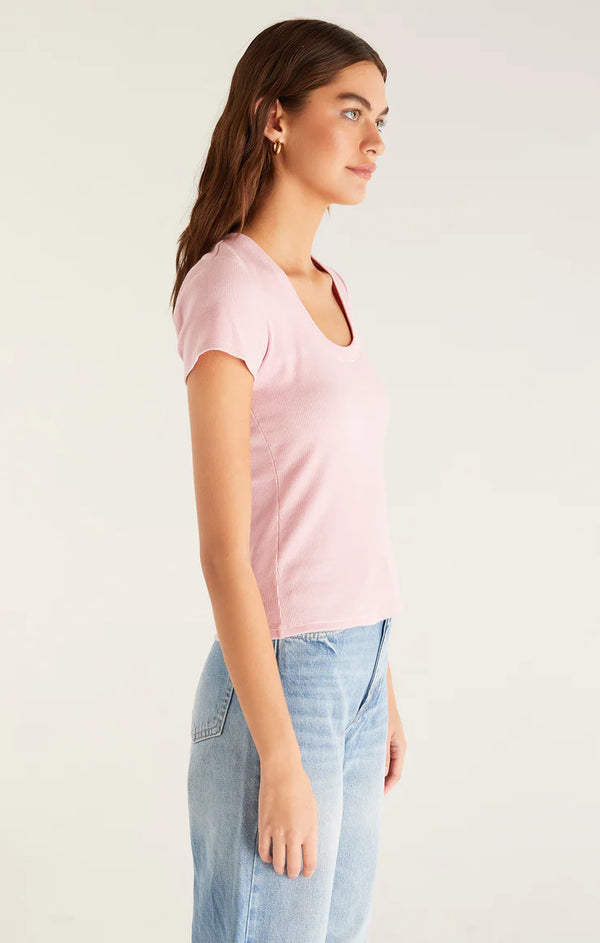 Side view of pink top. Model is wearing it untucked which showcases the skimmer length. 
